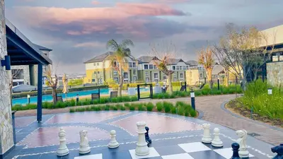 a chess board in a courtyard with a pool at Smart Home Oasis & Luxury Living in Midrand
