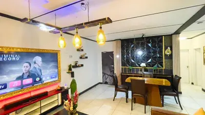 a dining room with a large tv and a table at Smart Home Oasis & Luxury Living in Midrand