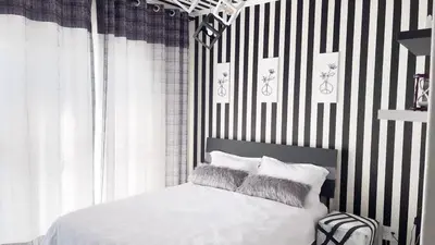 a bedroom with a bed with black and white stripes at Smart Home Oasis & Luxury Living in Midrand