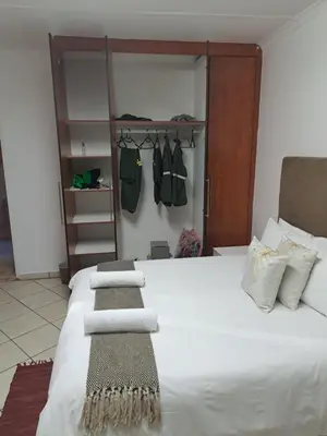 a bedroom with a bed with towels on it at Better Life Guesthouse Colbyn in Pretoria