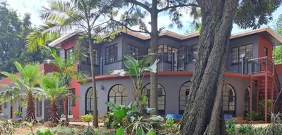 an image of a house with palm trees at Better Life Guesthouse Colbyn in Pretoria