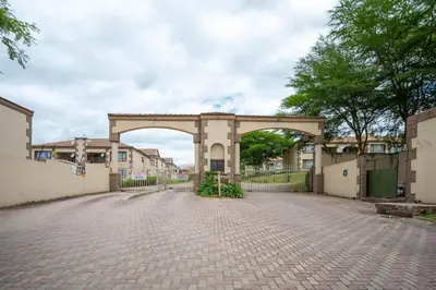 a building with an arch in the middle of a brick road at Self checkin - Modern 2 Bedroom Retreat - 103 in Nelspruit