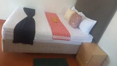 a bed with two ties on top of it at Matte guest house in Secunda in Secunda