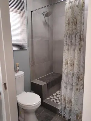 a bathroom with a shower curtain and a toilet at Kaldi Kothuis in Marble Hall