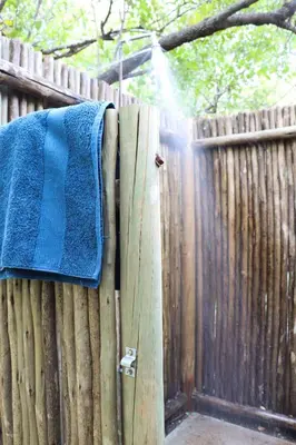 a blue towel is hanging on a wooden fence at Meulensrus in Hoedspruit