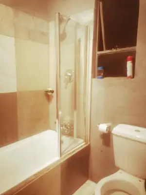 a bathroom with a shower and a toilet at Baroka Overnight Accommodation in Polokwane