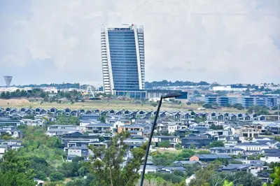 a city with a tall building in the background at Feelathome in Midrand