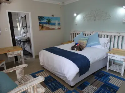a bedroom with a bed with two teddy bears on it at Isle La Breeze Guest House in Witbank