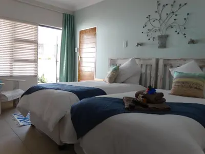 a bedroom with two beds with a teddy bear on them at Isle La Breeze Guest House in Witbank