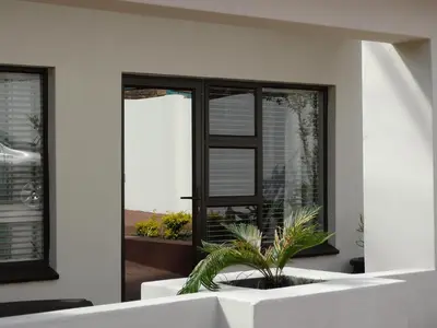 a house with a potted plant in front of a window at Isle La Breeze Guest House in Witbank