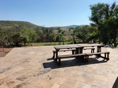a picnic table sitting on top of a patio at Kulanka Lodge in Roodeplaat