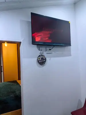 a flat screen tv hanging on a wall at The Cozy Cabin in Pretoria