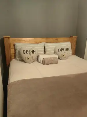 a bed with two pillows on top of it at The Cozy Cabin in Pretoria
