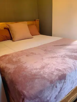 a close up of a large bed with at The Cozy Cabin in Pretoria