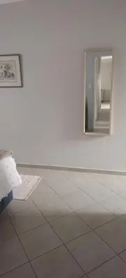 a white room with a mirror on the wall at Lerato's Guesthouse in Polokwane