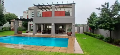 a house with a swimming pool in the yard at Secured Studio Apartment in Sandton