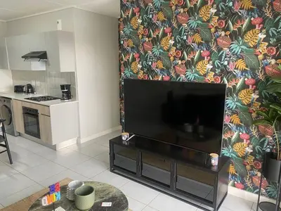 a living room with a flat screen tv on a wall at Big deana home in Pretoria