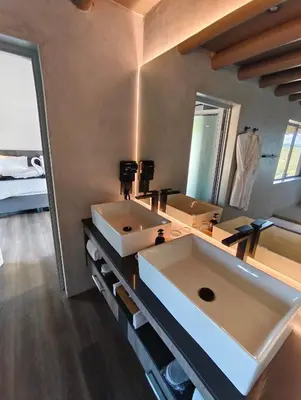 a bathroom with two sinks and a large mirror at Sitrah Private Lodge, Mabalingwe in Mabula