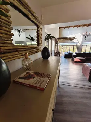 a living room with a counter with a book on it at Sitrah Private Lodge, Mabalingwe in Mabula