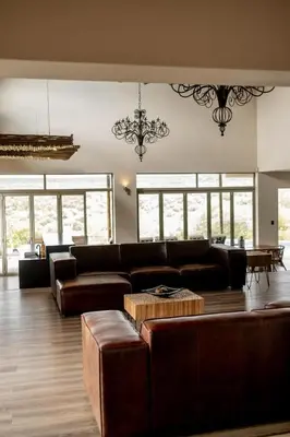 a living room with a couch and a table at Sitrah Private Lodge, Mabalingwe in Mabula