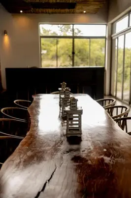 a long table in a room with chairs at Sitrah Private Lodge, Mabalingwe in Mabula