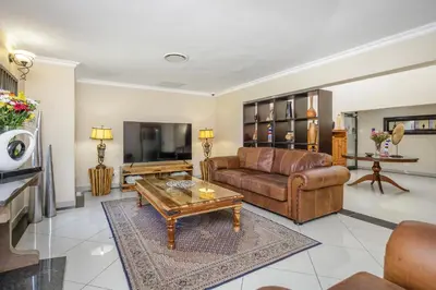a living room with a couch and a coffee table at Moyres Guest House in Witbank