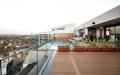 a balcony of a building with potted plants on it at Menlyn Maine Trilogy Collection in Pretoria