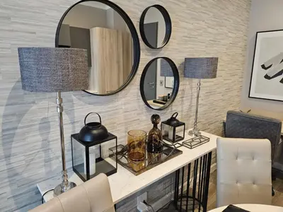 a living room with mirrors on the wall at Menlyn Maine Trilogy Collection in Pretoria