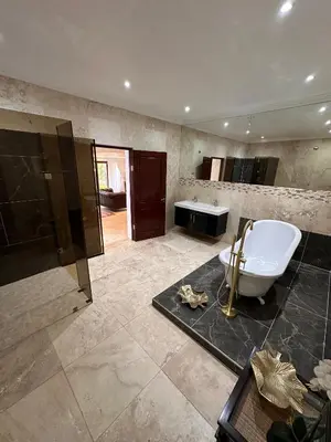 a large bathroom with a tub and a sink at Concordia Boutique Venue in Midrand
