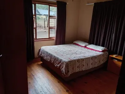 a small bedroom with a bed and a window at Snowy Owl in Burgersfort
