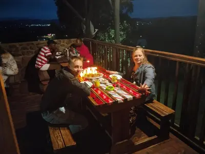 a man and a woman sitting at a table with candles at Snowy Owl in Burgersfort