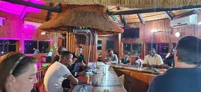 a group of people sitting at a bar at Snowy Owl in Burgersfort