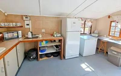 a small kitchen with a refrigerator and a counter at Inniberg Nylstroom in Nylstroom