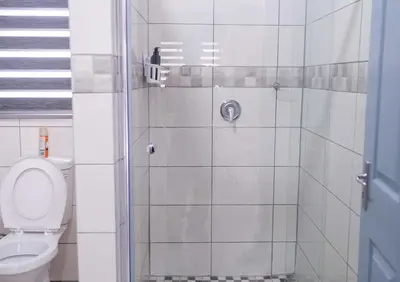 a bathroom with a shower with a toilet at Viata Luxe Guesthouse in Phalaborwa