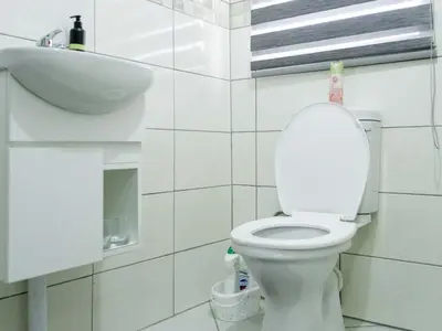 a bathroom with a white toilet and a sink at Viata Luxe Guesthouse in Phalaborwa