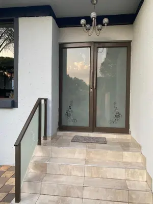 a front door of a house with a glass at Bridgelamour Guest house1 in Hartbeespoort