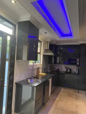 a kitchen with a sink and a blue ceiling at Bridgelamour Guest house1 in Hartbeespoort