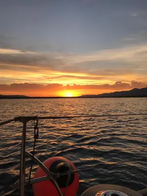 a view of a sunset from a boat in the water at THE GALLARY INN, Kosmos, Hartbeespoort in Hartbeespoort