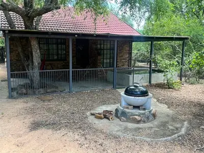 a building with a bird cage in front of a house at Hello Kruger Hideaway in Marloth Park
