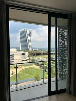 a window with a view of a large building at Riamus Luxury Apartment in Midrand