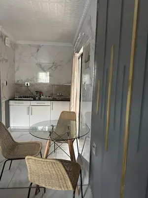 a dining room with a glass table and chairs at Wayside Guesthouse in Witbank