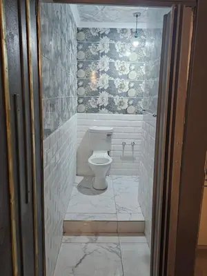 a bathroom with a white toilet in a room at Wayside Guesthouse in Witbank