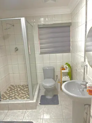 a bathroom with a shower and a toilet and a sink at Beautiful Customized Hide Out in Centurion