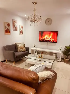 a living room with a couch and a fireplace at Beautiful Customized Hide Out in Centurion
