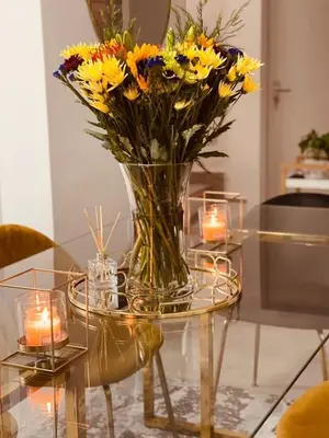 a vase of flowers on a glass table with candles at HMT Modern House in Centurion