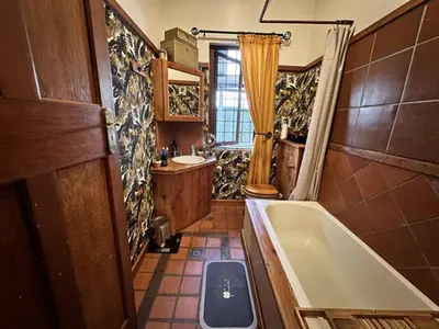a bathroom with a bath tub and a sink at Villa 21 in Pretoria