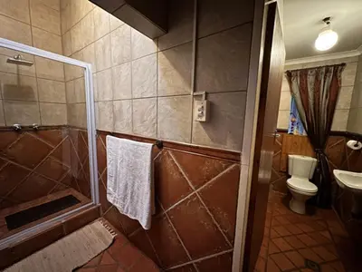 a bathroom with a shower and a toilet at Villa 21 in Pretoria
