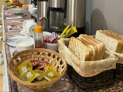 a table with a basket of bread and sandwiches at Hazyhaven Guest House in Hazyview