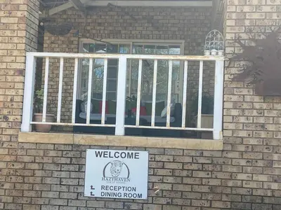 a house with a welcome sign in front of a window at Hazyhaven Guest House in Hazyview