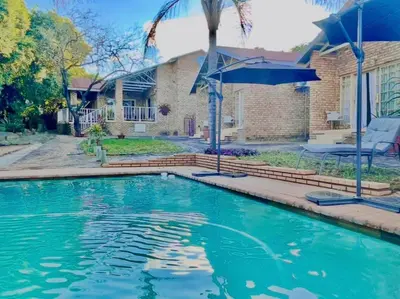 a swimming pool in front of a house at Hazyhaven Guest House in Hazyview